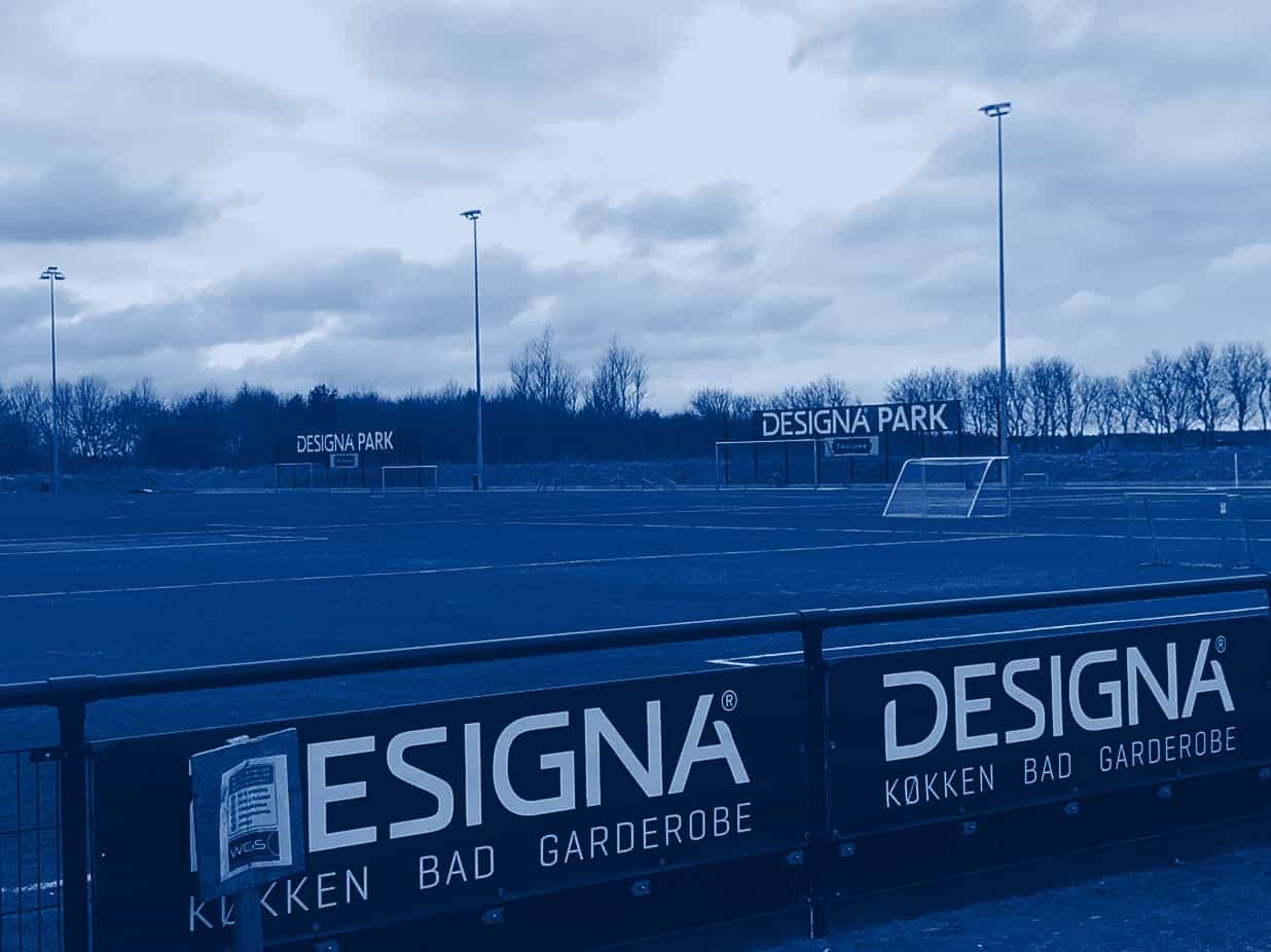 Sponsorbander monteret på rækværket langs en kunstgræsbane